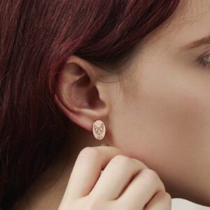 Custom pet portrait oval stud earrings in rose gold, engraved dog photo earrings worn on ear