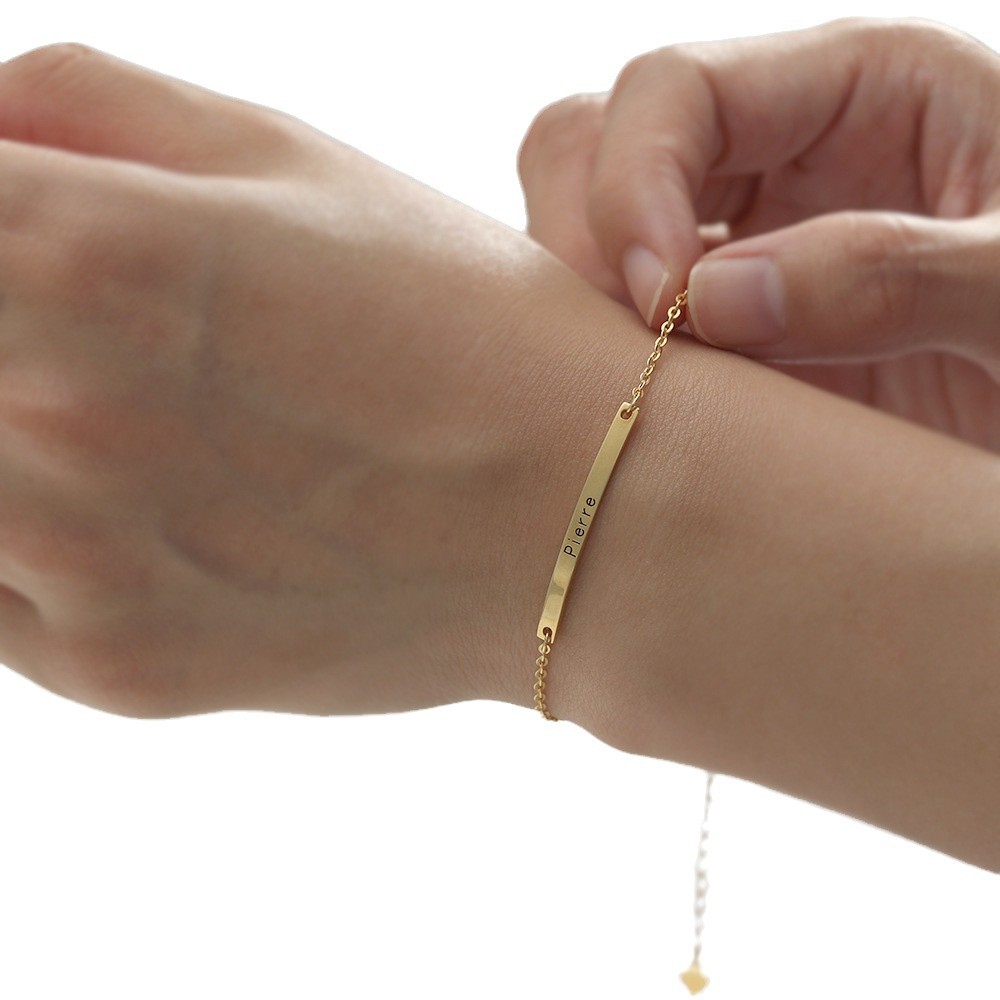 Minimalist gold engraved bar bracelet on wrist, everyday personalized jewelry gift for her