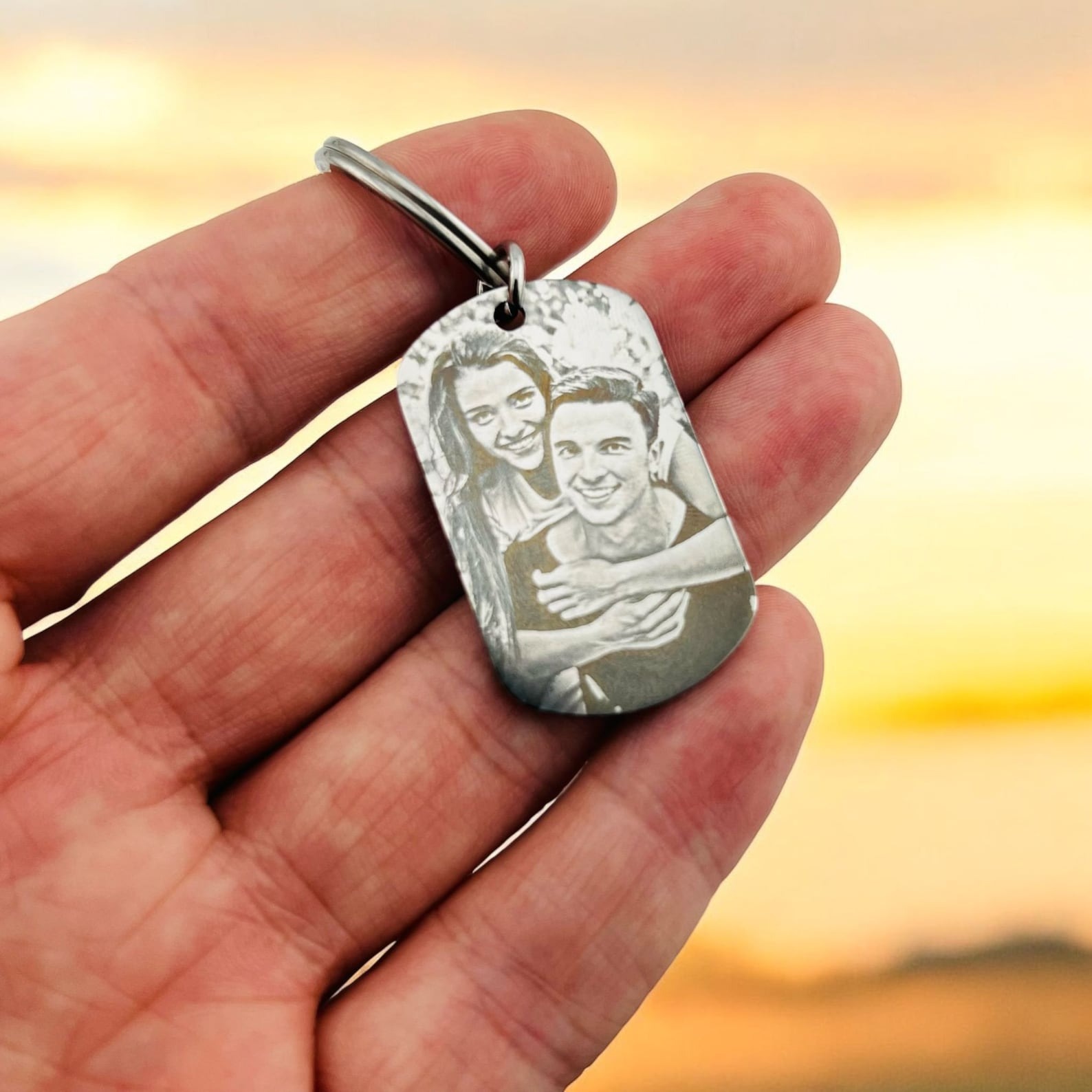 Hand holding personalized photo keychain, dog tag memorial gift
