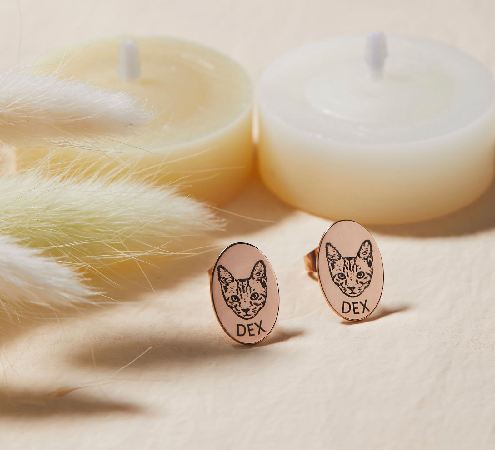 Pair of custom pet photo oval stud earrings flat lay, gold tone memorial jewelry