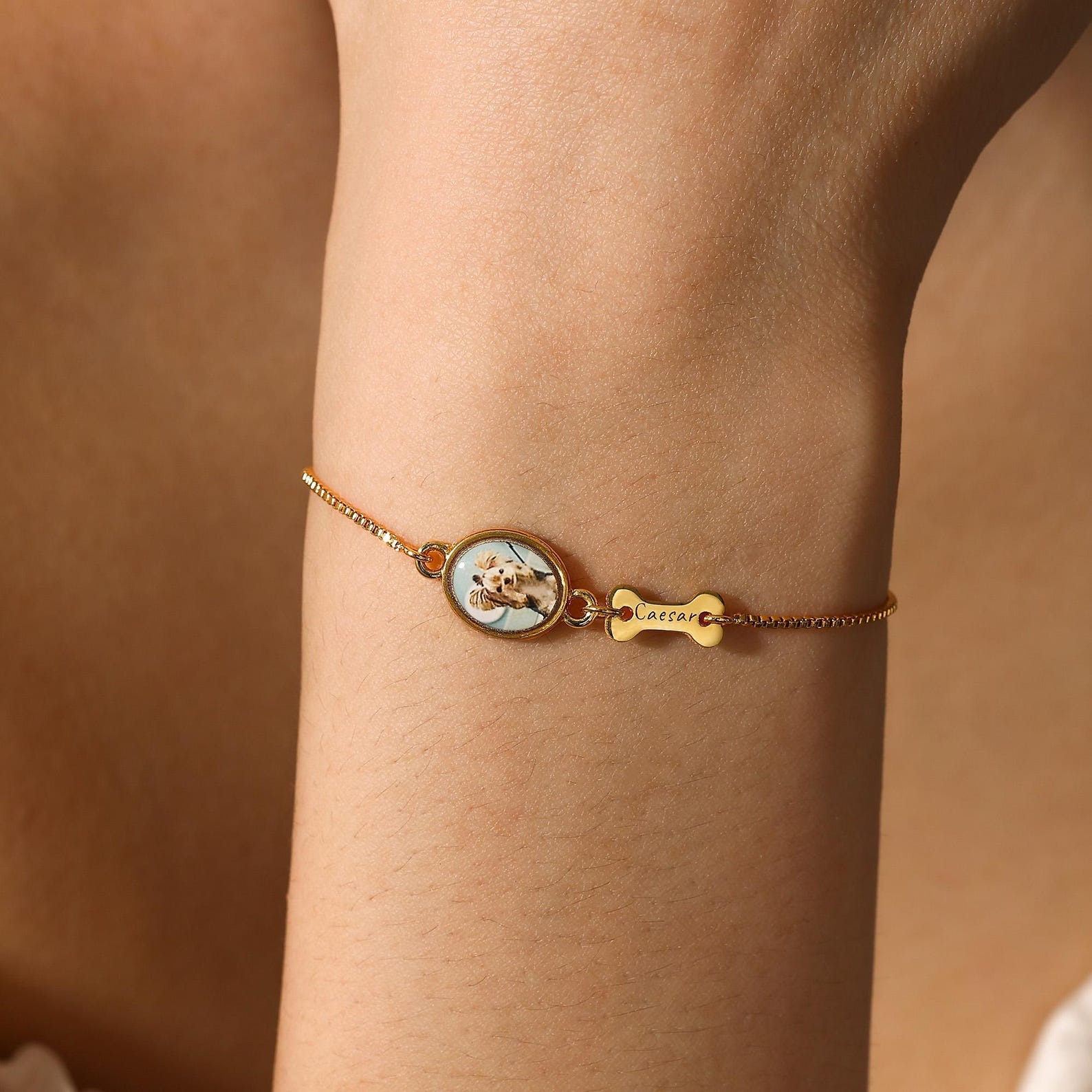 Personalized dog memorial bracelet worn on woman's wrist, custom pet photo bracelet with engraved bone name plate