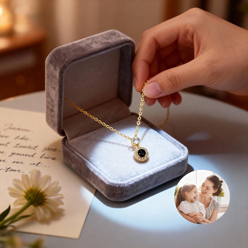 Gold halo projection necklace in gray velvet gift box, hand holding chain, mother and child projected photo inset