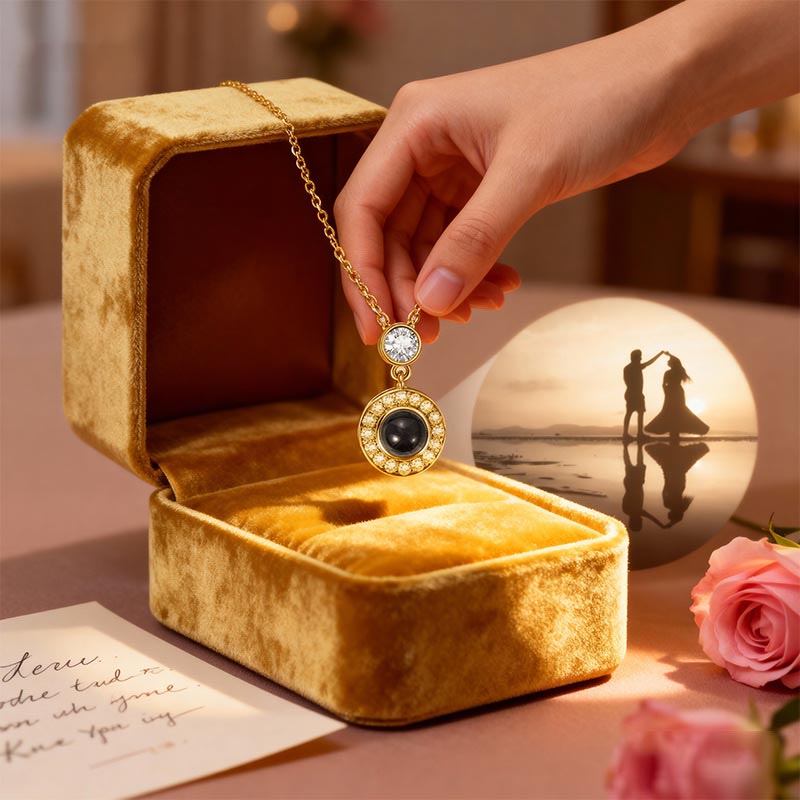 Gold double circle projection necklace in golden velvet box, sunset couple silhouette projecting from crystal