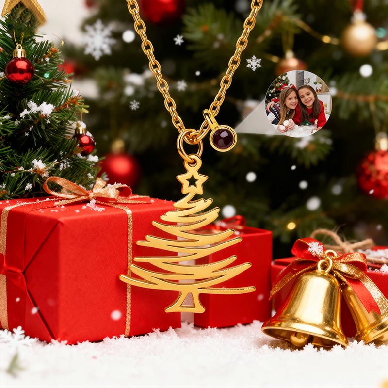 Gold minimalist Christmas tree necklace in festive holiday scene, red gift box and golden bells