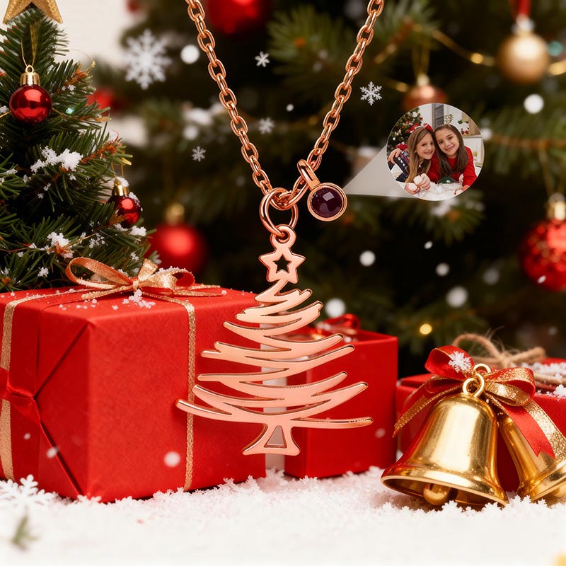 Rose gold minimalist Xmas tree projection necklace, festive scene with gift boxes and bells