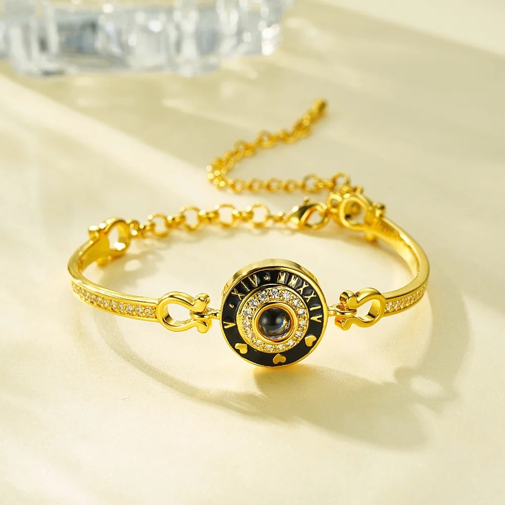Gold Roman numeral clock projection bangle close up, elegant anniversary jewelry detail