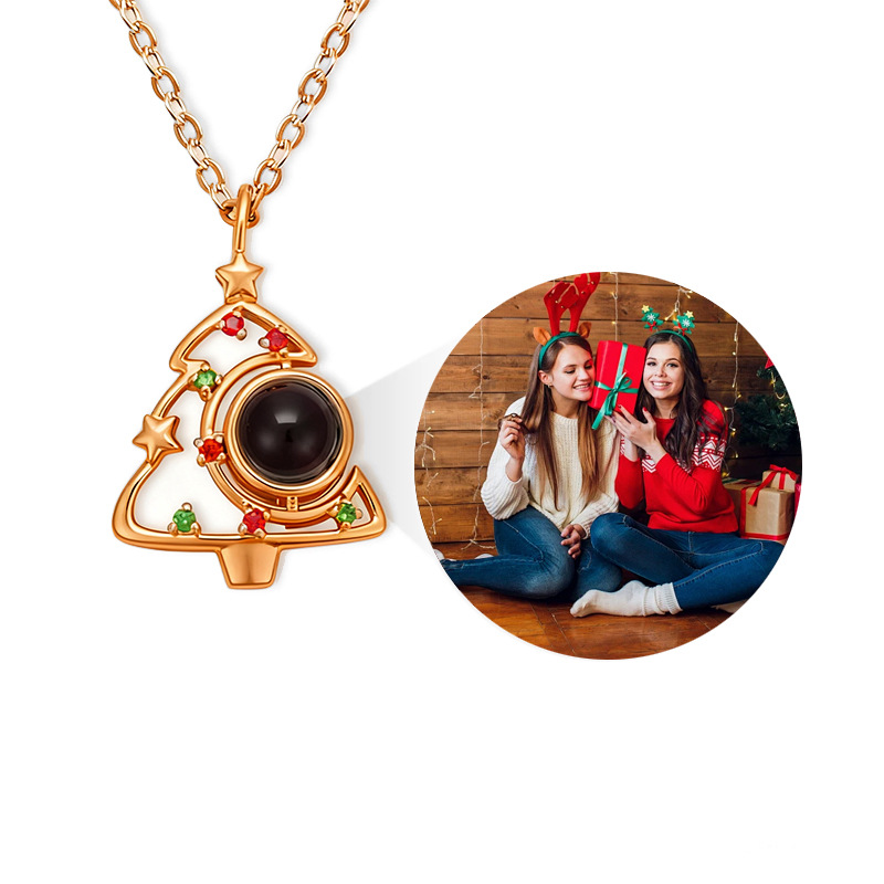 Rose gold Christmas tree picture necklace, showing projected two friends in festive holiday outfits