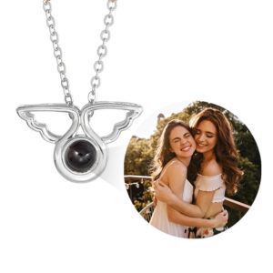 Silver custom angel wings picture necklace, showing projected photo of two friends inside crystal orb
