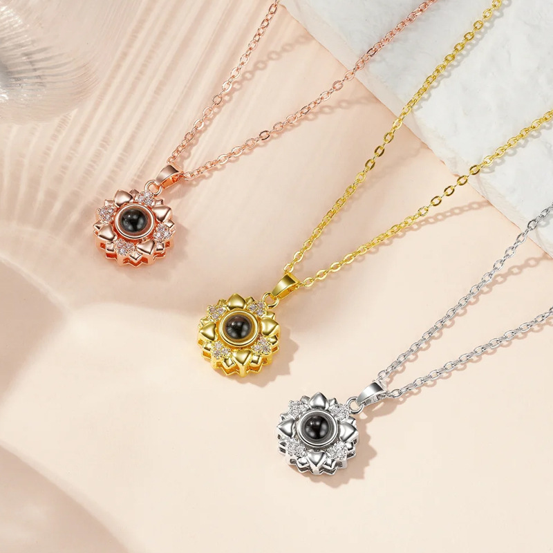 Sunflower heart petals projection necklaces in rose gold, gold and silver, floral pendants flat lay