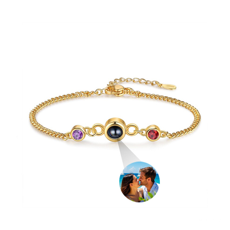 Gold double birthstone photo projection bracelet on white, couple photo projecting from center crystal