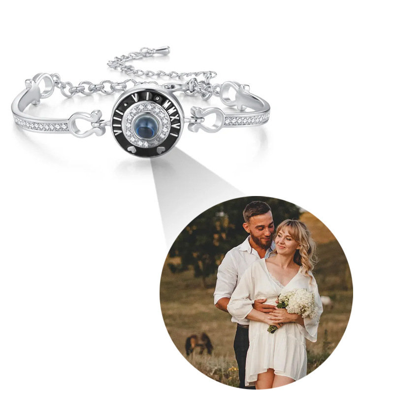 Silver Roman numeral clock photo projection bangle on white, couple photo projecting from center crystal