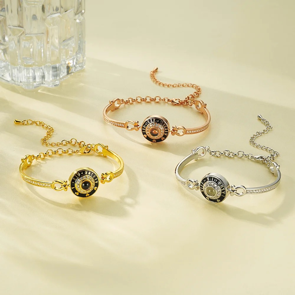 Roman numeral clock projection bangles in silver, gold and rose gold, elegant timepiece jewelry flat lay
